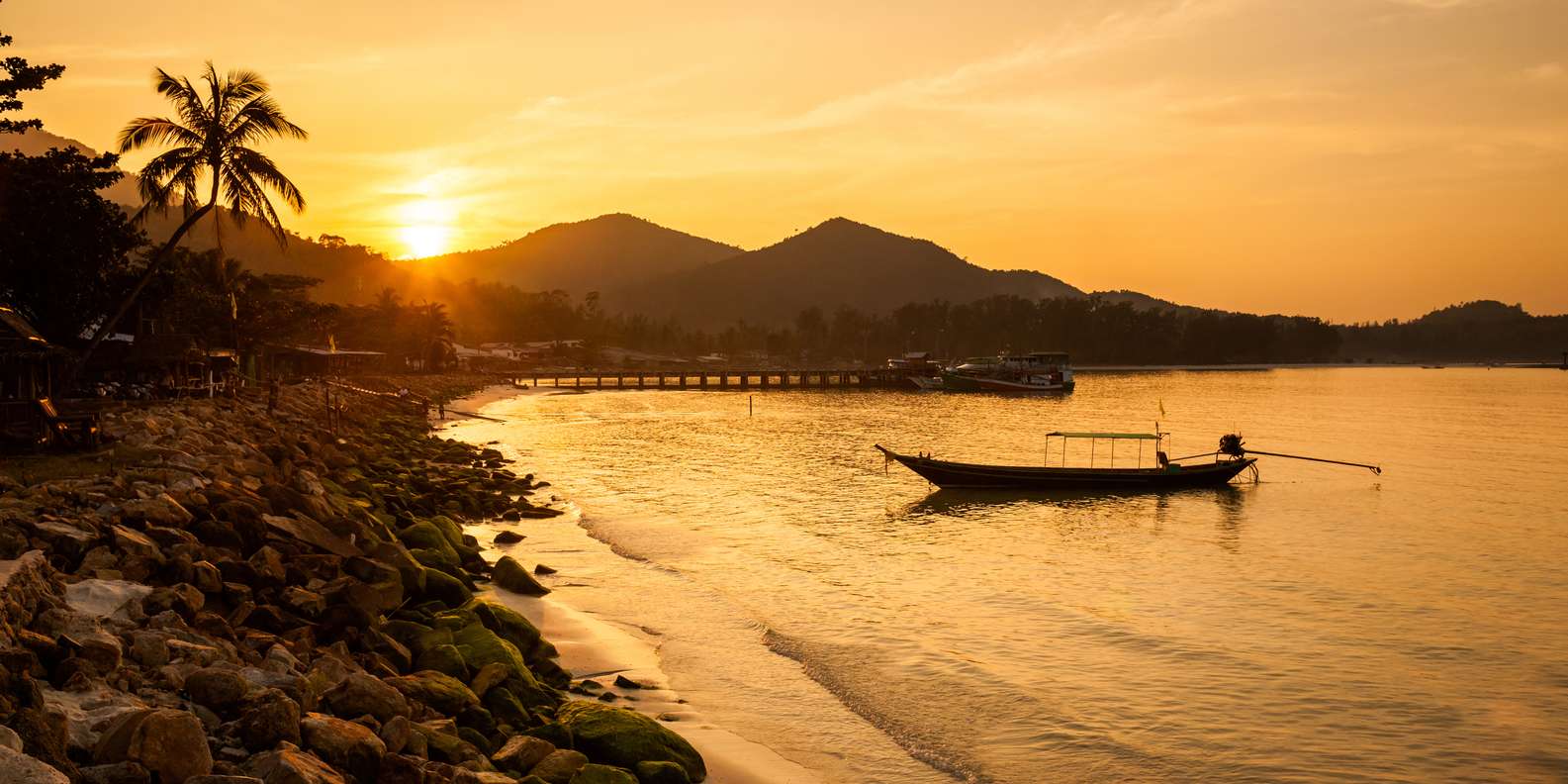 Sunset over a thai longtail boat in Koh Phangan