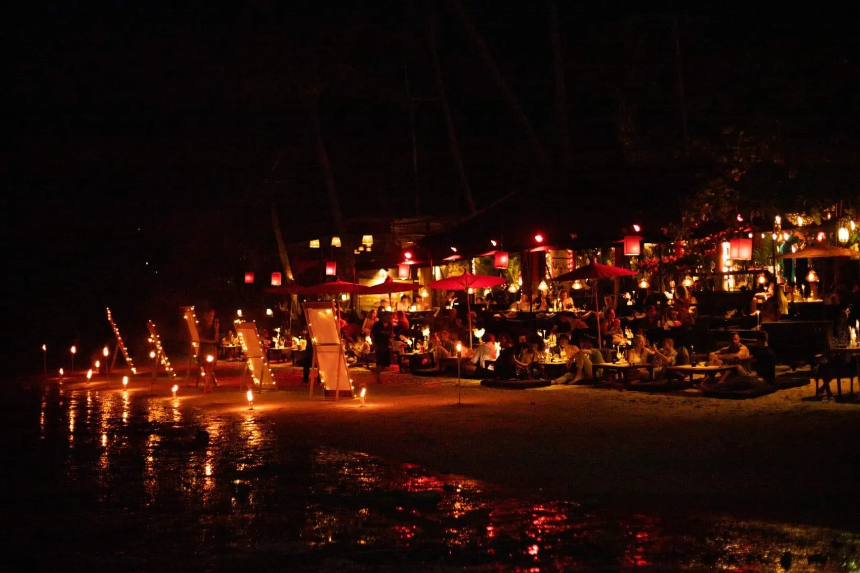 A candlelit table set for two on the beach at sunset, Koh Phangan, Thailand