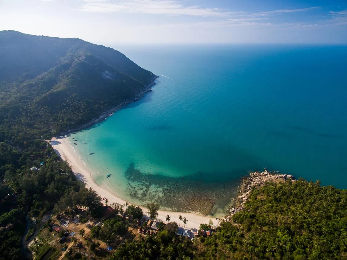 Aerial view of a turquoise Koh Phangan bay — stories from The Dar Mansour Journal